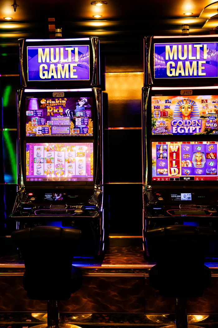 Mastering the First Impression: Your intriguing post title goes here Colorful multi-game slot machines inside a lively casino environment at night.